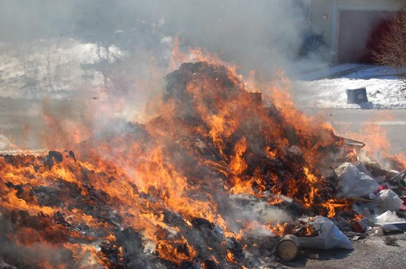 garbage truck dumps load on fire