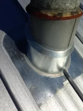 [Hearth.com] Stove pipe flashing on corrugated metal roof.