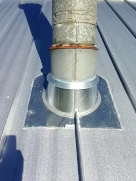 [Hearth.com] Stove pipe flashing on corrugated metal roof.