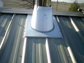 [Hearth.com] Stove pipe flashing on corrugated metal roof.