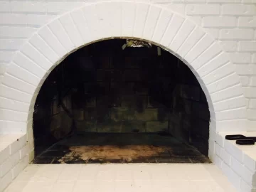 [Hearth.com] Larger stove in fireplace or smaller out of fireplace?