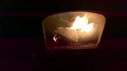 [Hearth.com] Fire behind the burn pot of a Harman Accentra FS...