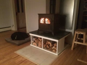 [Hearth.com] A woodstove storyVermont Castings Intrepid on soapstone hearth with built in wood box