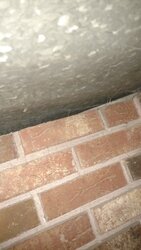 Insulating above stove, between metal and brick?