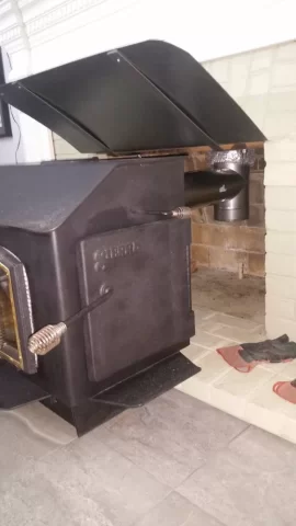 [Hearth.com] Freestanding stove install venting through masonry fireplace.