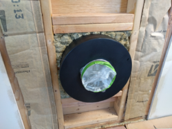 Insulation with paper facing in wall behind stove