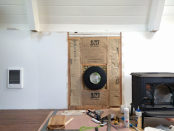 Insulation with paper facing in wall behind stove