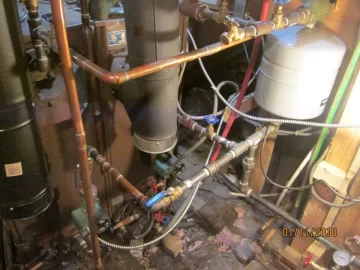 [Hearth.com] Two indoor boilers plumbed together.