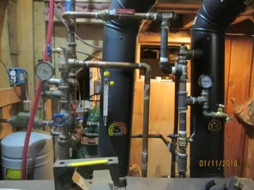 [Hearth.com] Two indoor boilers plumbed together.