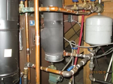 [Hearth.com] Two indoor boilers plumbed together.