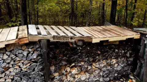 [Hearth.com] My idea of covering wood with pallets to create overhang.