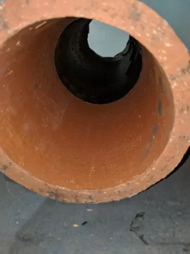 [Hearth.com] Stove pipe through clay thimble