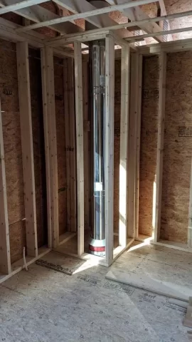 [Hearth.com] Second floor chimney enclosure in bedroom.