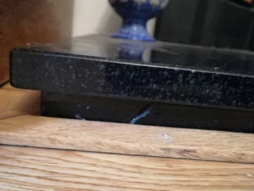 [Hearth.com] Granite hearth damaged by lack of floorboard expansion gap