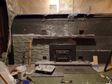 [Hearth.com] Stacked stone over painted fireplace