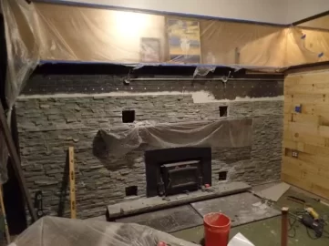 [Hearth.com] Stacked stone over painted fireplace