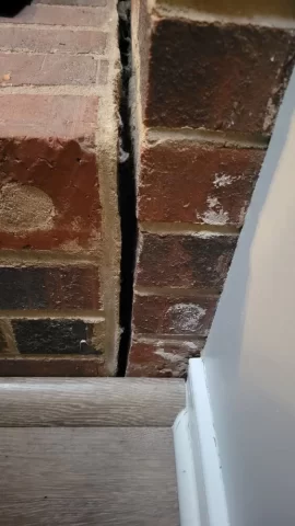 [Hearth.com] Brick hearth separating from main fireplace structure.