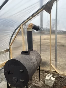 [Hearth.com] Barrel stove in a greenhouse