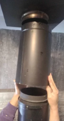 [Hearth.com] smoke coming out of the flue pipe as it goes into the ceiling box