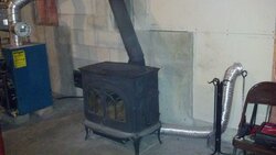 Wood stove in basement next to oil furnace