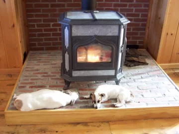 [Hearth.com] Your pup enjoying the stove or insert.