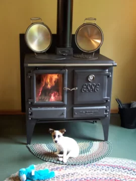 [Hearth.com] Your pup enjoying the stove or insert.