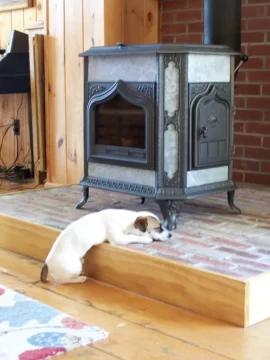 [Hearth.com] Your pup enjoying the stove or insert.