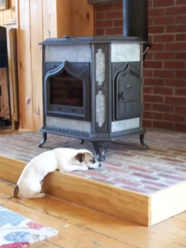 [Hearth.com] Your pup enjoying the stove or insert.