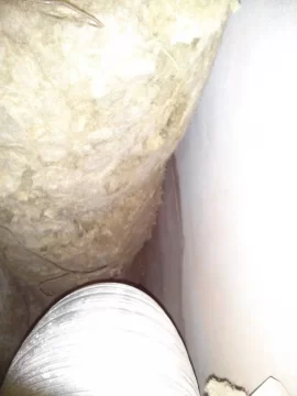 [Hearth.com] Exposed rockwool insulation around flue in decompression enclosure