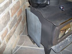 Heat shield mounted to wood stove