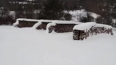 [Hearth.com] Snow covered wood stacks